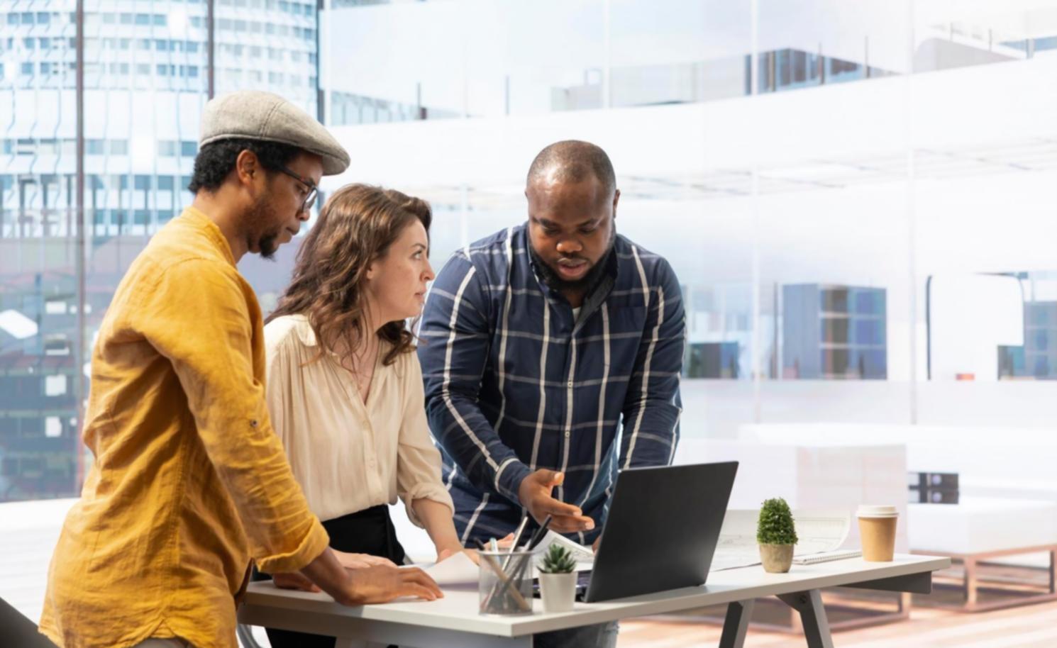 Students working together on budget software during a practical training session